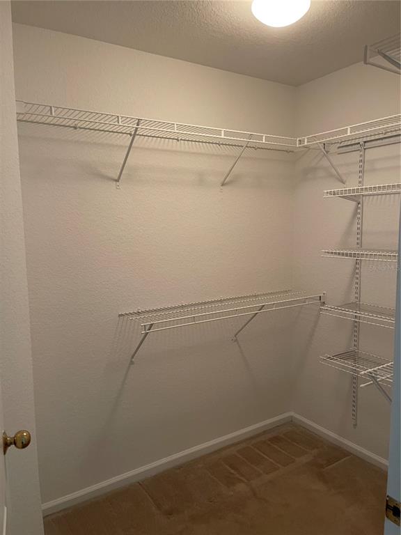 7617 Bayport Road, Unit 57 Orlando, FL 32819 - Photo 18 of 39 a view of a room with racks on the wall