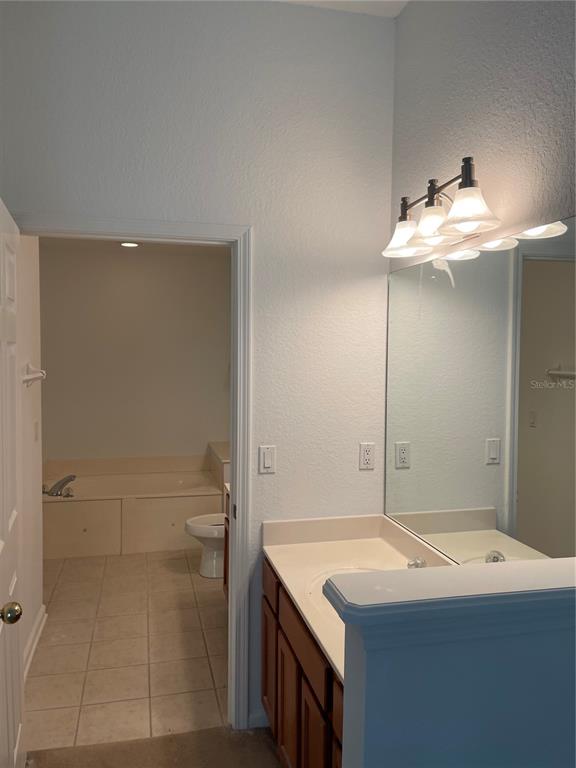 7617 Bayport Road, Unit 57 Orlando, FL 32819 - Photo 19 of 39 a bathroom with a sink and a mirror