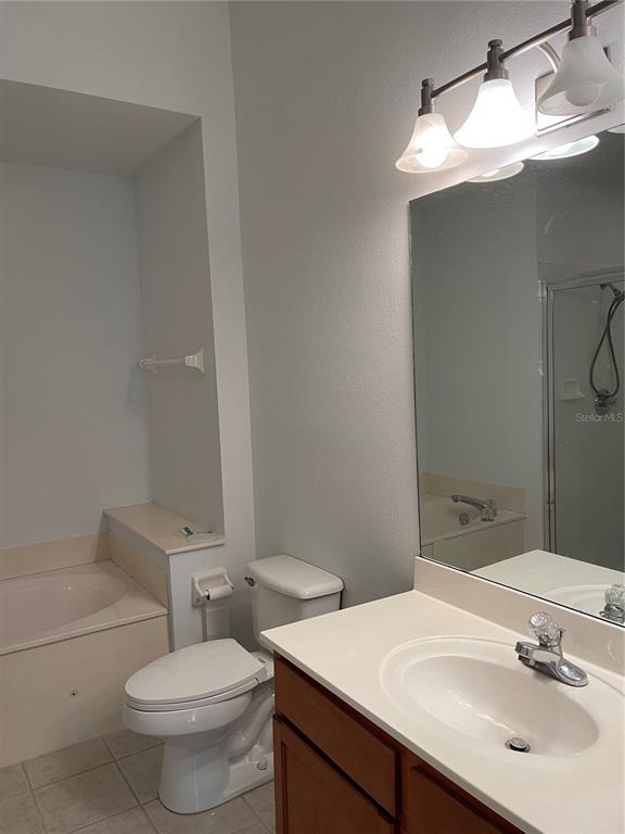 7617 Bayport Road, Unit 57 Orlando, FL 32819 - Photo 20 of 39 a bathroom with a sink toilet and a mirror