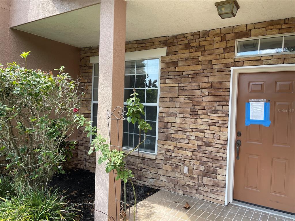 7617 Bayport Road, Unit 57 Orlando, FL 32819 - Photo 2 of 39 a couple of potted plants in front of door