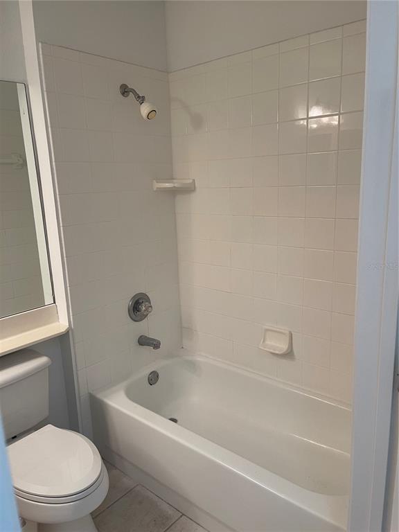 7617 Bayport Road, Unit 57 Orlando, FL 32819 - Photo 22 of 39 a white bath tub sitting next to a toilet