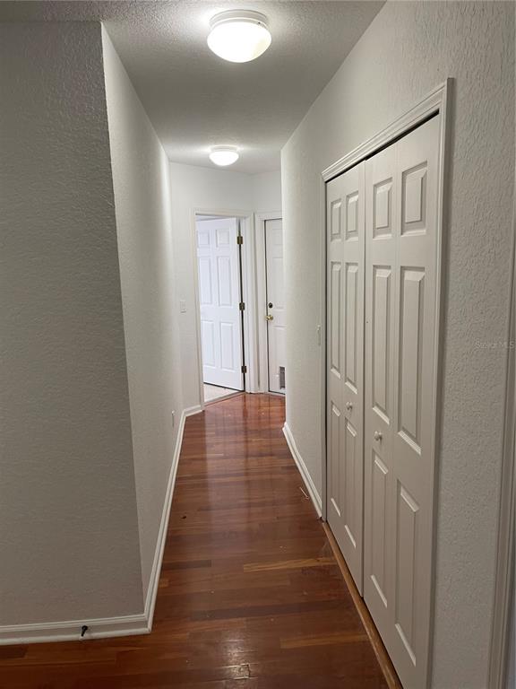 7617 Bayport Road, Unit 57 Orlando, FL 32819 - Photo 27 of 39 a view of a hallway with wooden floor