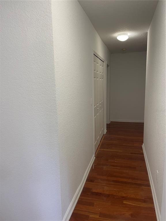 7617 Bayport Road, Unit 57 Orlando, FL 32819 - Photo 31 of 39 a view of a hallway with wooden floor