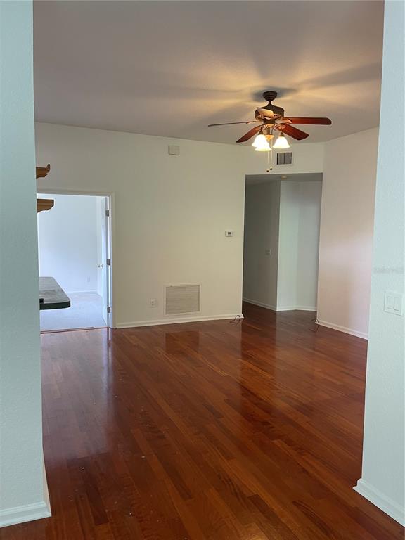 7617 Bayport Road, Unit 57 Orlando, FL 32819 - Photo 38 of 39 a view of a livingroom with a chandelier fan and wooden floor