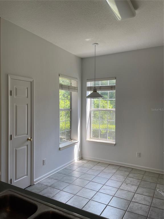 7617 Bayport Road, Unit 57 Orlando, FL 32819 - Photo 6 of 39 an empty room with windows