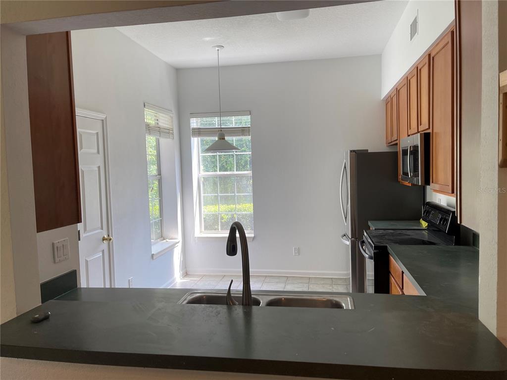 7617 Bayport Road, Unit 57 Orlando, FL 32819 - Photo 9 of 39 a view of a hallway with workspace