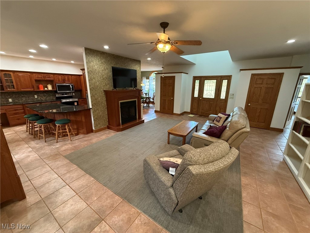 2178 Pleasant Valley Road Northeast New Philadelphia, OH 44663 - Photo 6 of 50 Living area with recessed lighting, a ceiling fan, a large fireplace, and light tile patterned floors