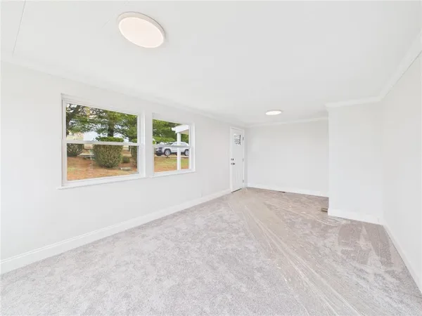 a large white kitchen with white cabinets and a granite counter tops
