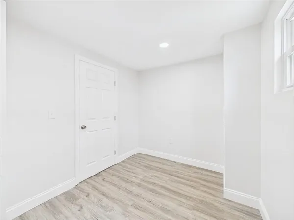 a view of a room with wooden floor and window