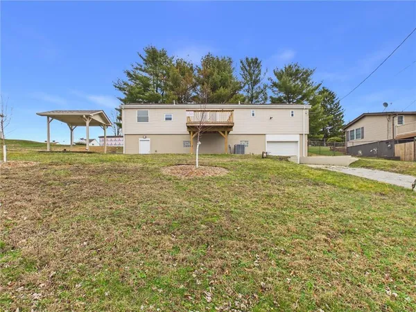 a view of a house with a backyard