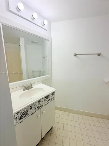 a bathroom with a sink a vanity and a mirror