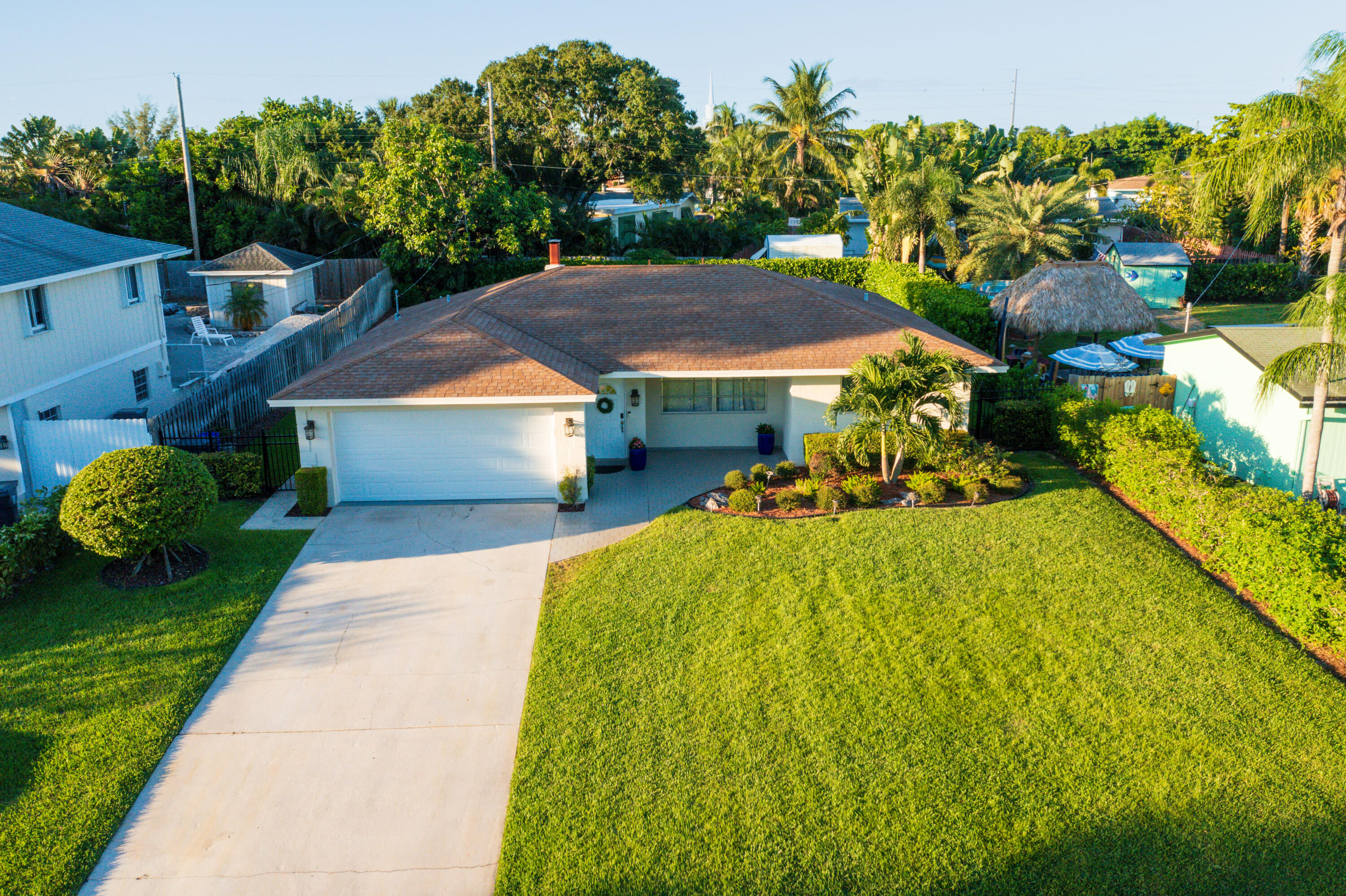 a front view of a house with a yard and trees