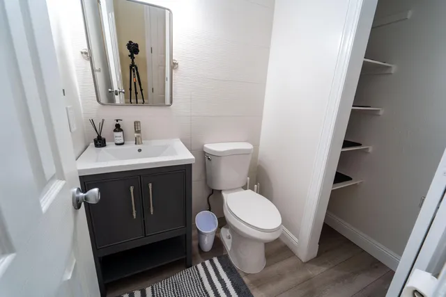 a bathroom with a toilet sink and mirror
