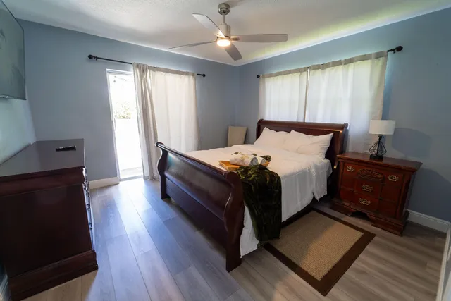 a bed sitting in a spacious bedroom next to a window