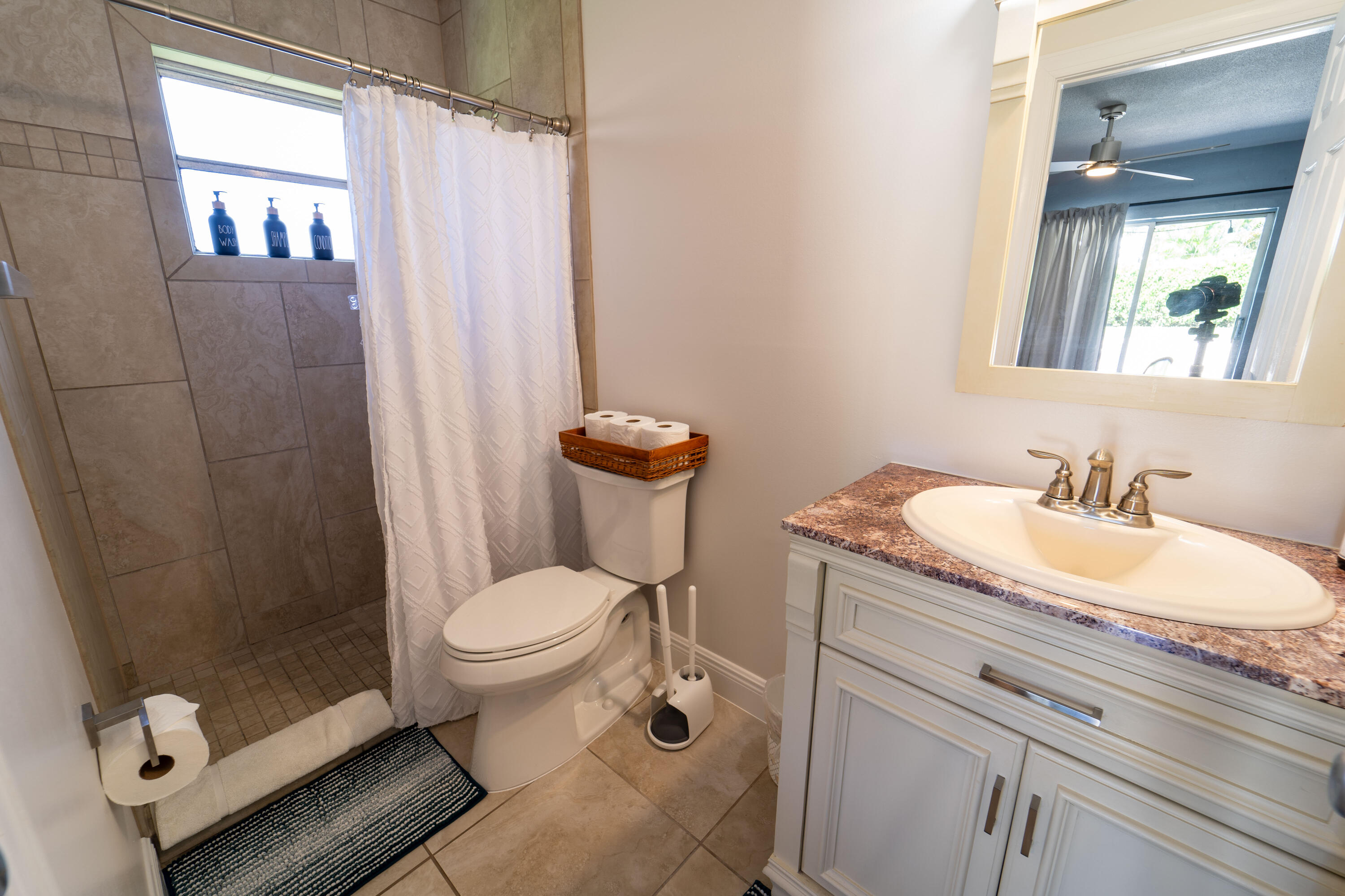 Undisclosed Address Lake Worth, FL 33461 - Photo 15 of 33 a bathroom with a granite countertop toilet sink and mirror
