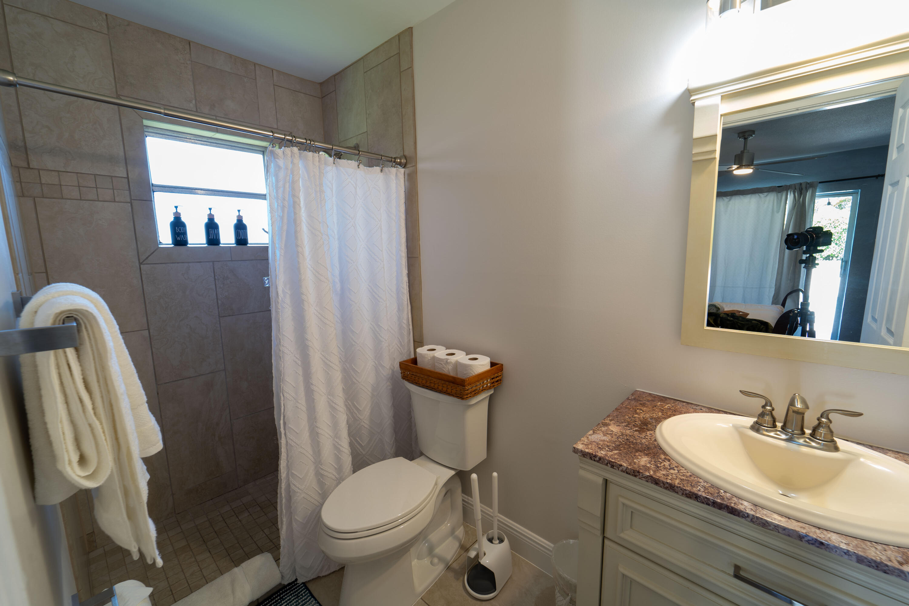 Undisclosed Address Lake Worth, FL 33461 - Photo 17 of 33 a bathroom with a granite countertop sink a toilet a mirror and shower