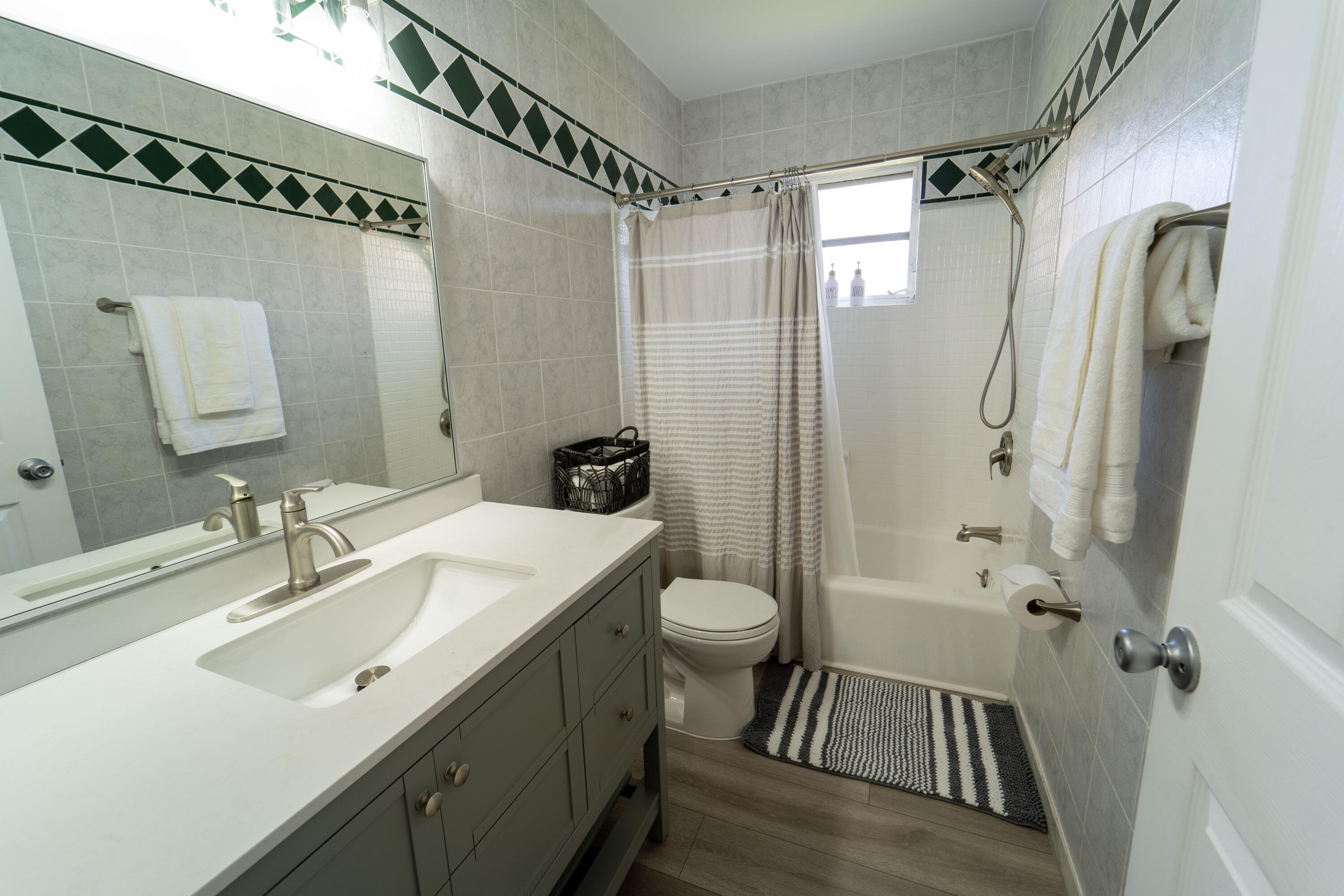 Undisclosed Address Lake Worth, FL 33461 - Photo 18 of 33 a bathroom with a sink a toilet a mirror a vanity and shower