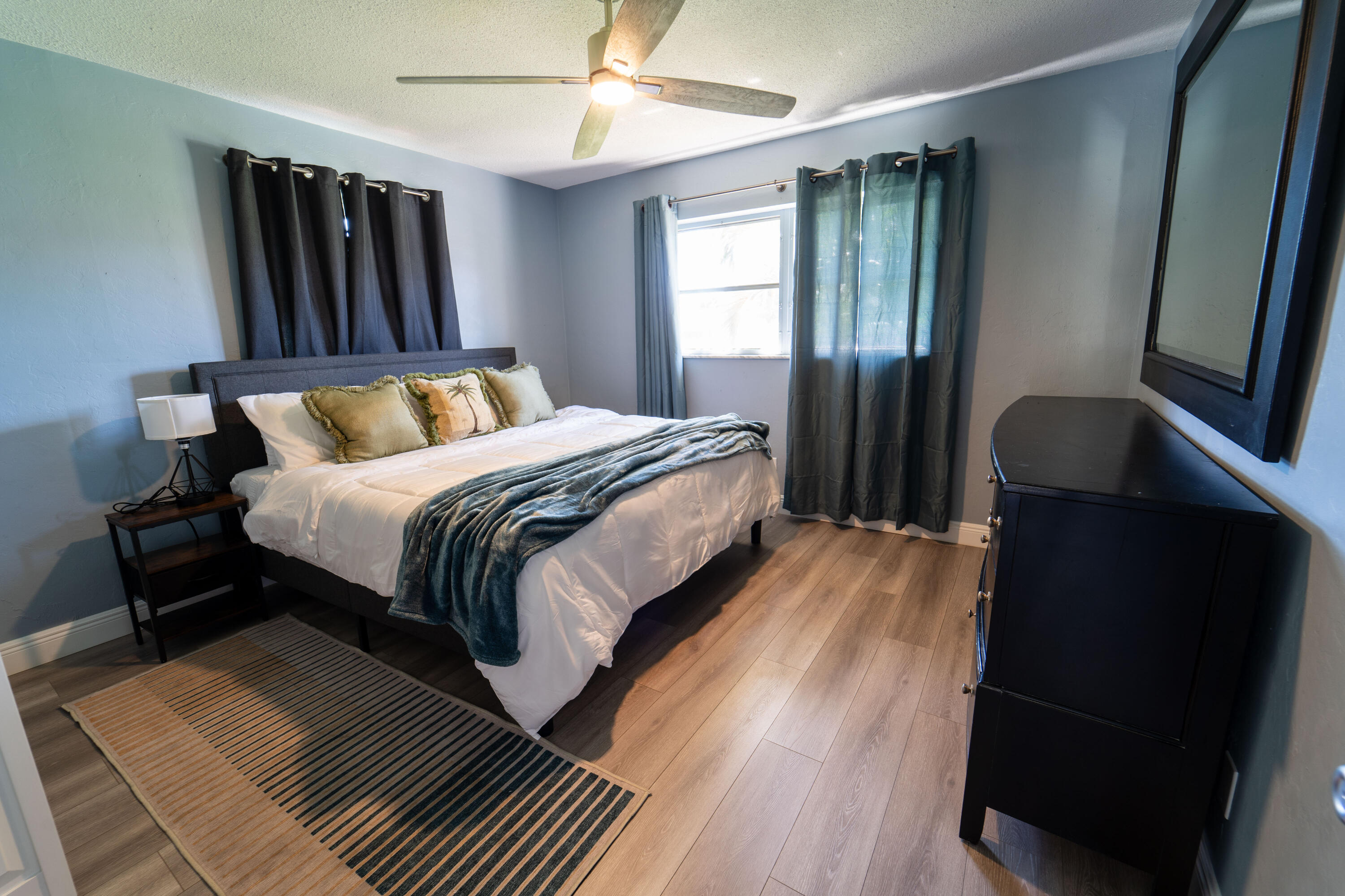 Undisclosed Address Lake Worth, FL 33461 - Photo 20 of 33 a bedroom with double bed and a window