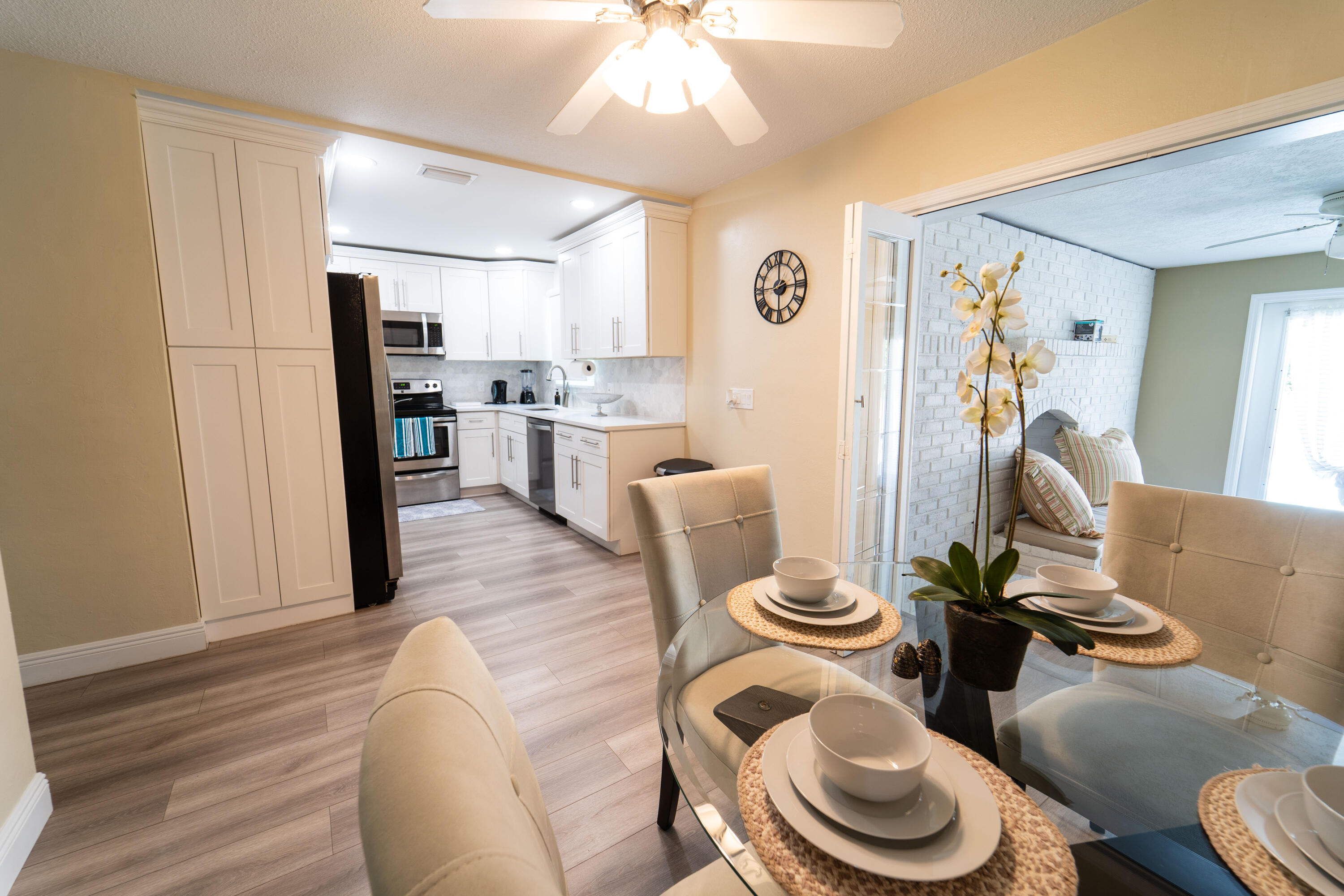Undisclosed Address Lake Worth, FL 33461 - Photo 4 of 33 a kitchen with stainless steel appliances a dining table and chairs