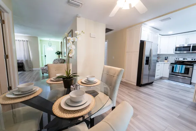 a dining room with furniture and wooden floor