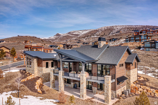 1282 Chimney Rock Road, Unit 344 Heber City, UT 84032 - Photo 52 of 55 Modern mountain home featuring extensive stone and wood siding, multiple decks, and a large covered patio