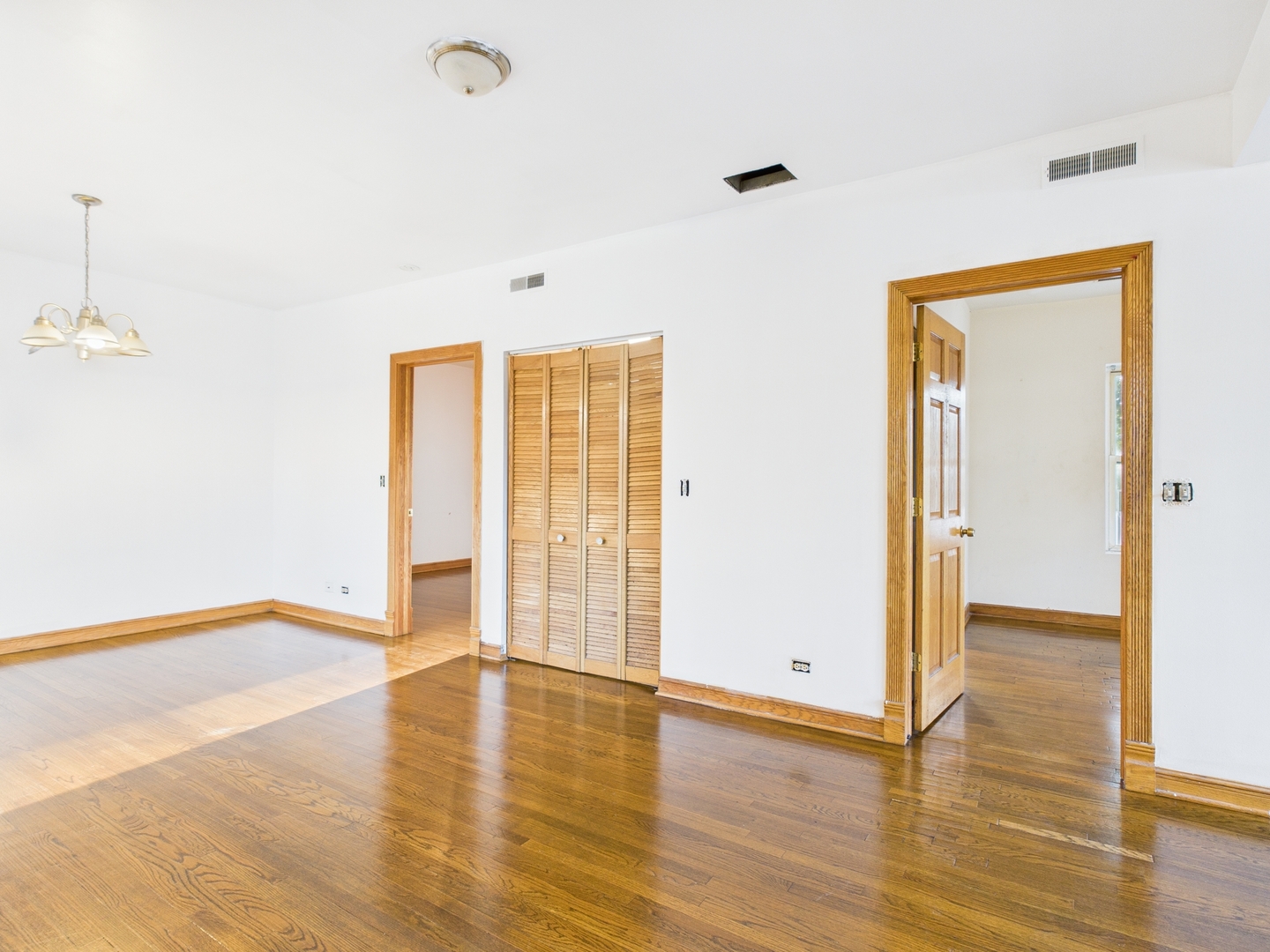 6652 South University Avenue, Unit 3B Chicago, IL 60637 - Photo 11 of 14 a view of an empty room with wooden floor and a window