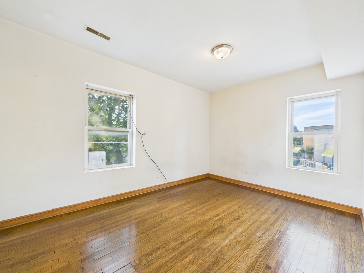 6652 South University Avenue, Unit 3B Chicago, IL 60637 - Photo 14 of 14 a view of an empty room with wooden floor and a window
