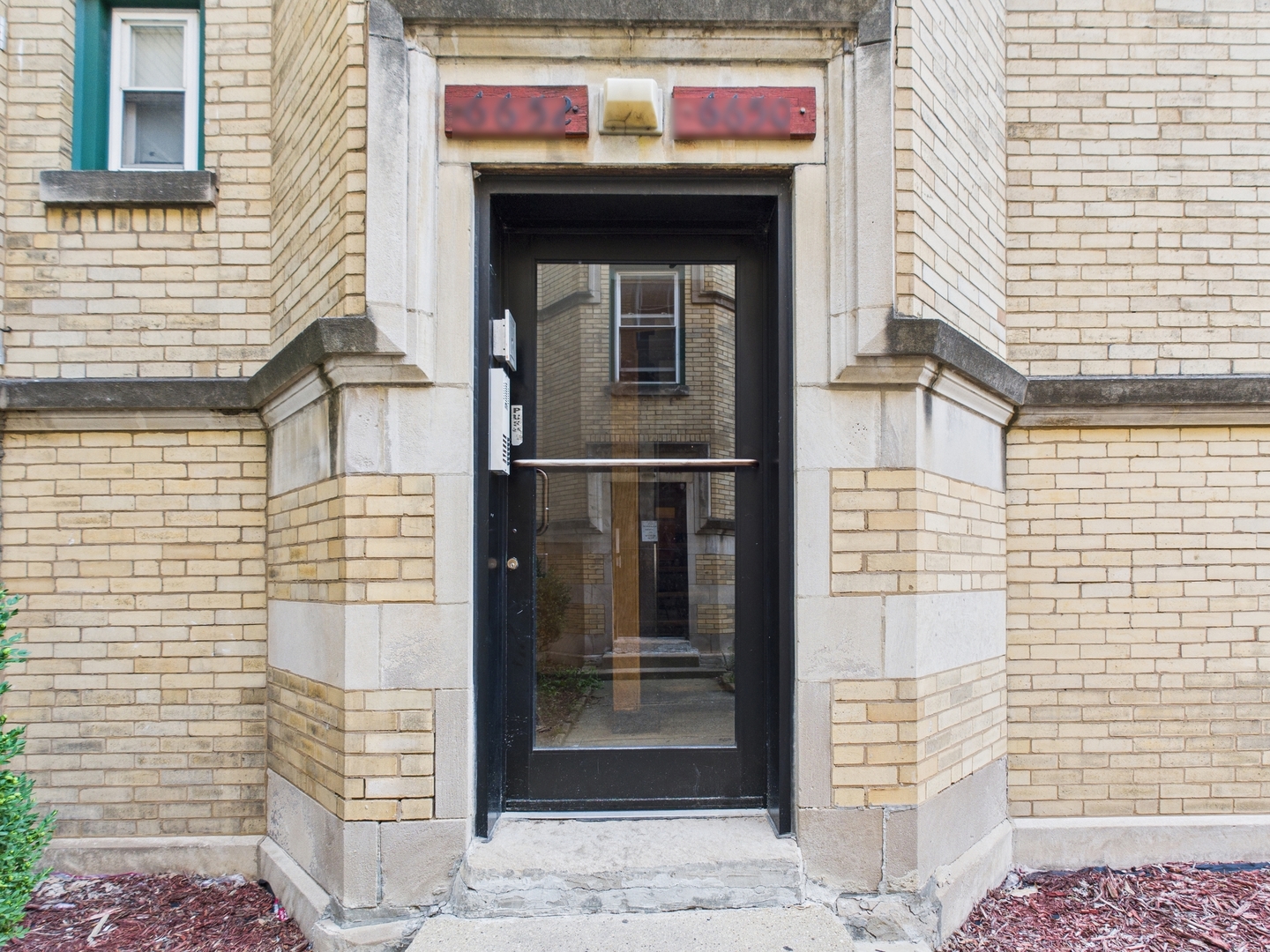 6652 South University Avenue, Unit 3B Chicago, IL 60637 - Photo 2 of 14 a front view of a building with glass door