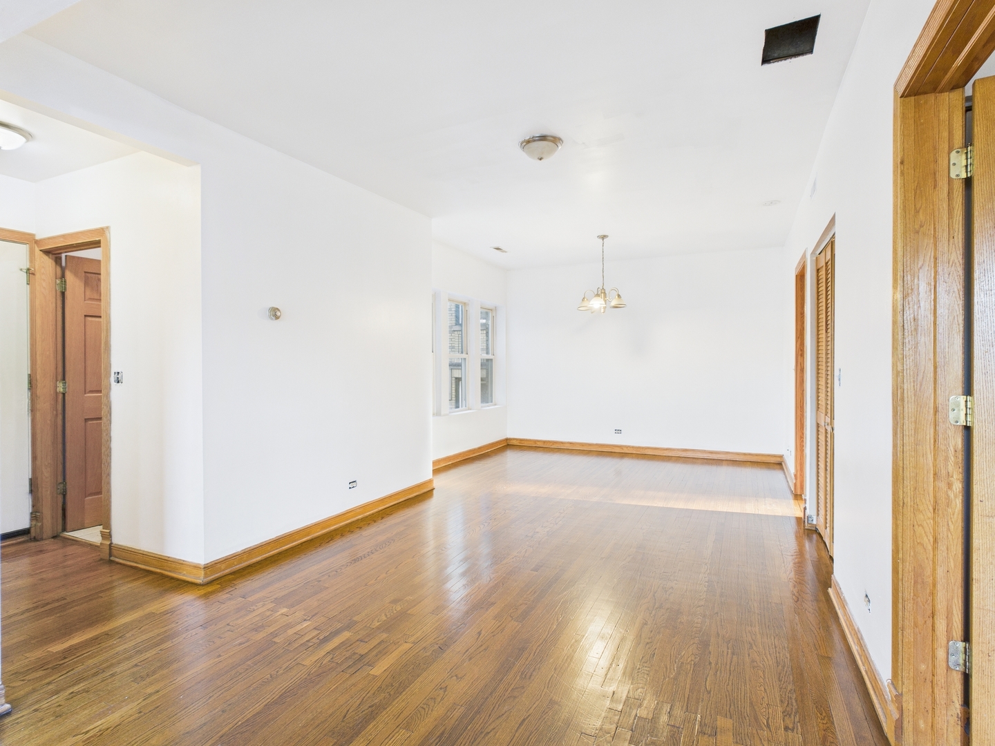 6652 South University Avenue, Unit 3B Chicago, IL 60637 - Photo 9 of 14 a view of empty room with wooden floor and fan