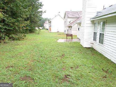 636 Rayella Drive Stockbridge, GA 30281 - Photo 12 of 13 a view of a backyard with plants and a bench