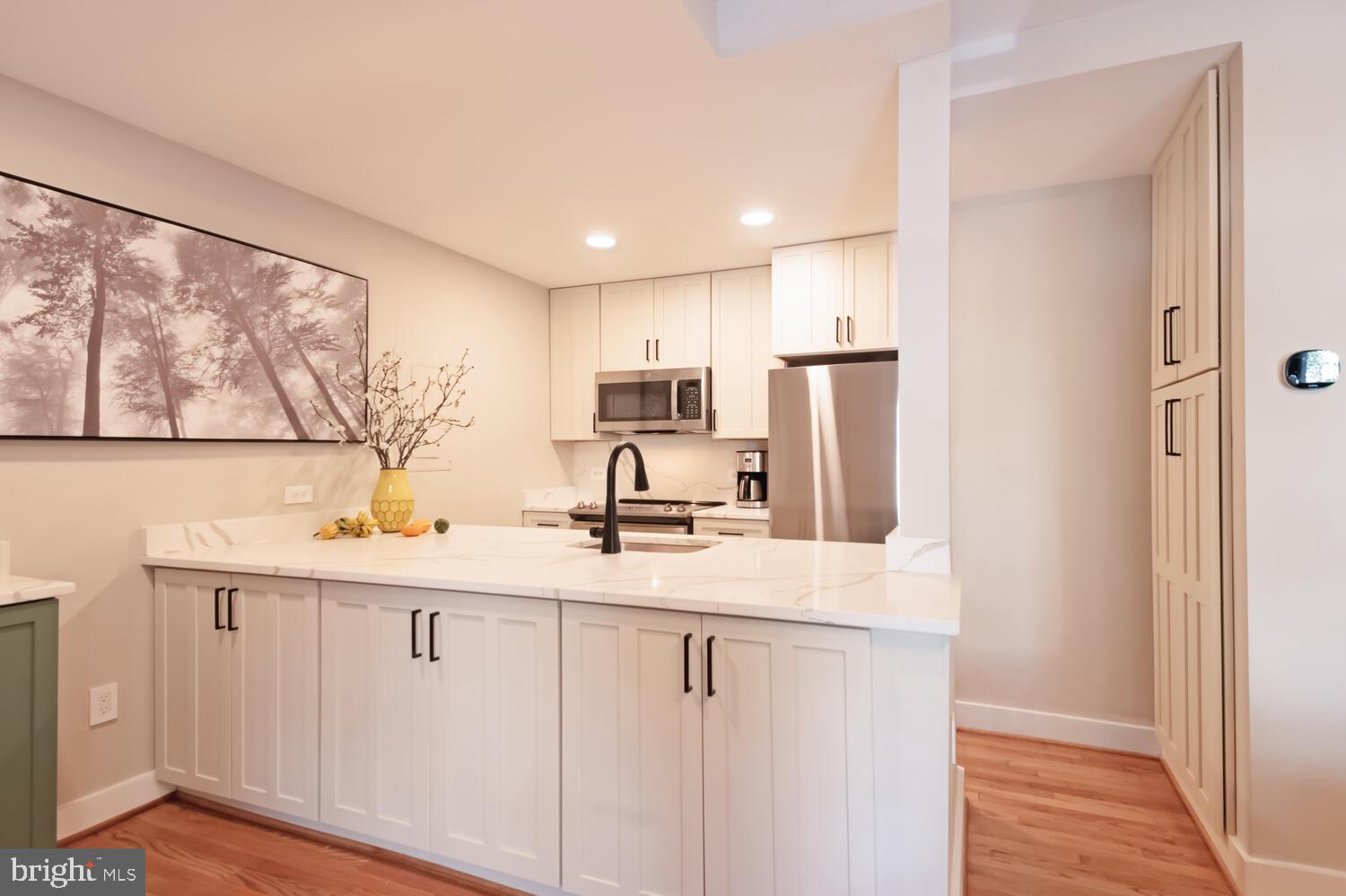 1840 California Street Northwest, Unit 2A Washington, DC 20009 - Photo 8 of 26 Large Kitchen Island With White Marble-Look Quartz