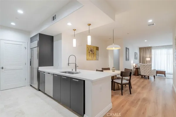 a kitchen with sink table and chairs
