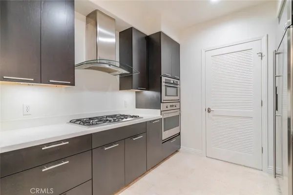 a kitchen with stainless steel appliances granite countertop a refrigerator and a stove