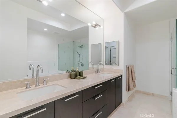 a bathroom with a double vanity sink and a mirror