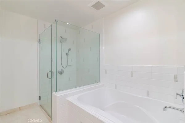 a white bath tub sitting next to a shower
