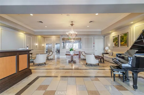 a view of a dining room with furniture a chandelier and wooden floor