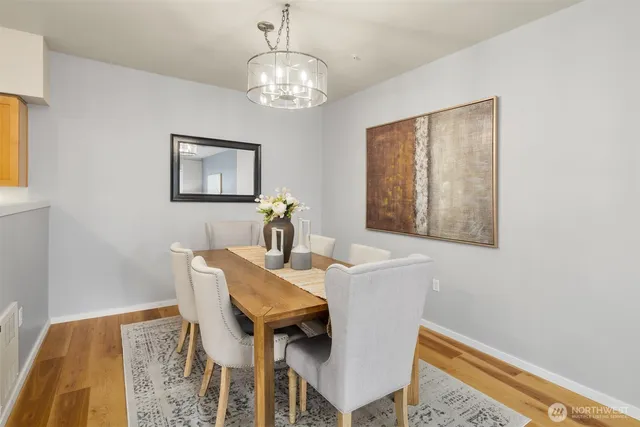 a view of a dining room with furniture and chandelier