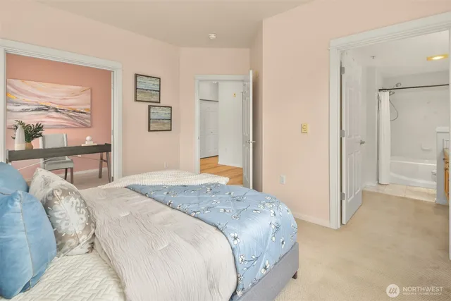 a bedroom with a bed and a large window