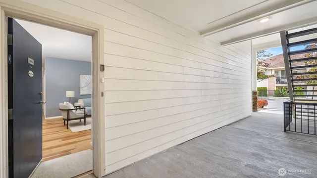 a view of a hallway with wooden floor and windows