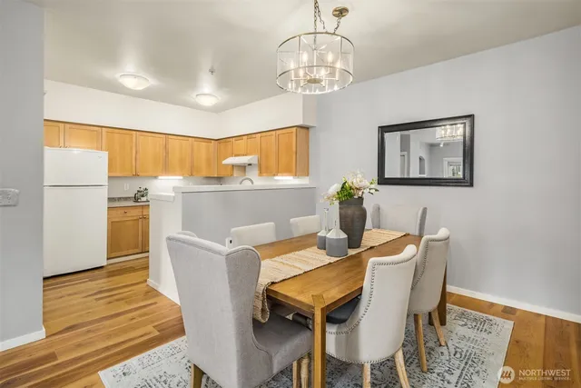 a view of a dining room with furniture wooden floor and chandelier