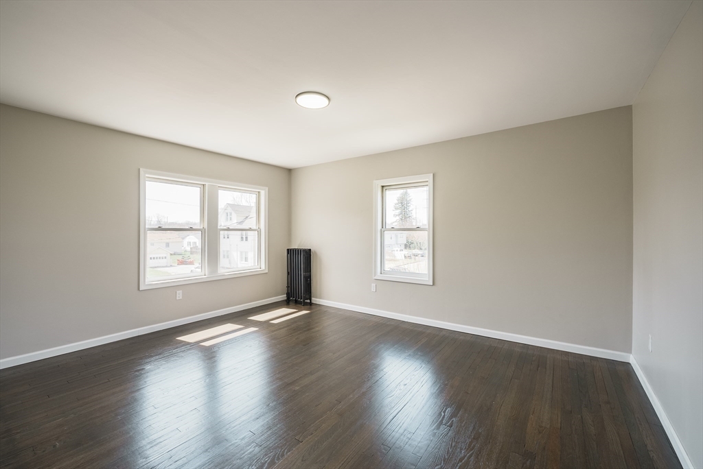 10 Bill Street Chicopee, MA 01013 - Photo 22 of 41 a view of an empty room with wooden floor and window