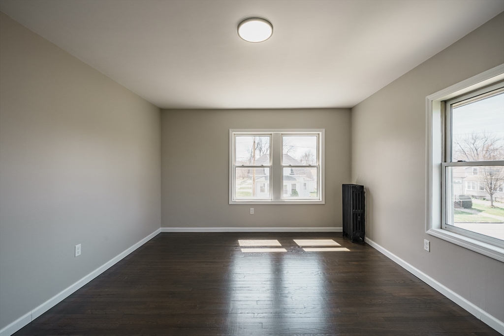 10 Bill Street Chicopee, MA 01013 - Photo 23 of 41 wooden floor in an empty room with a window