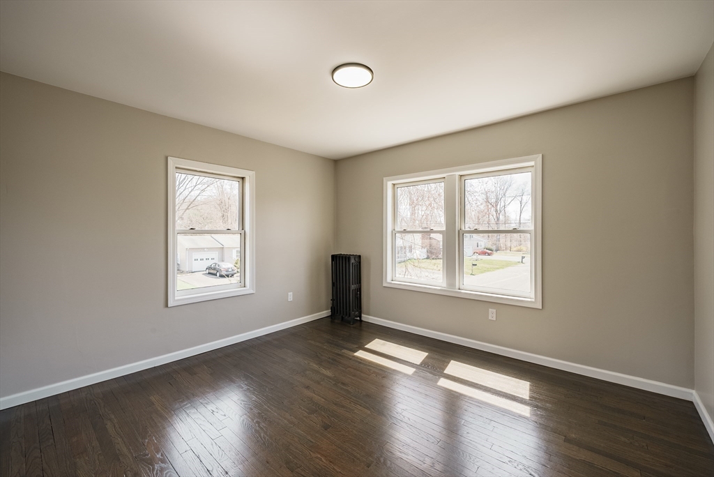 10 Bill Street Chicopee, MA 01013 - Photo 27 of 41 a view of an empty room with wooden floor and a window