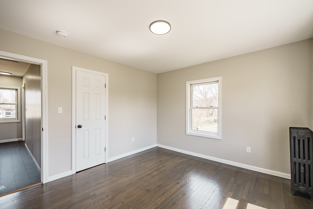 10 Bill Street Chicopee, MA 01013 - Photo 28 of 41 an empty room with wooden floor and windows