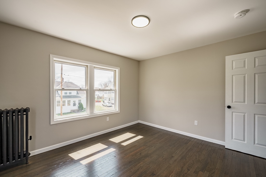 10 Bill Street Chicopee, MA 01013 - Photo 29 of 41 an empty room with wooden floor and windows