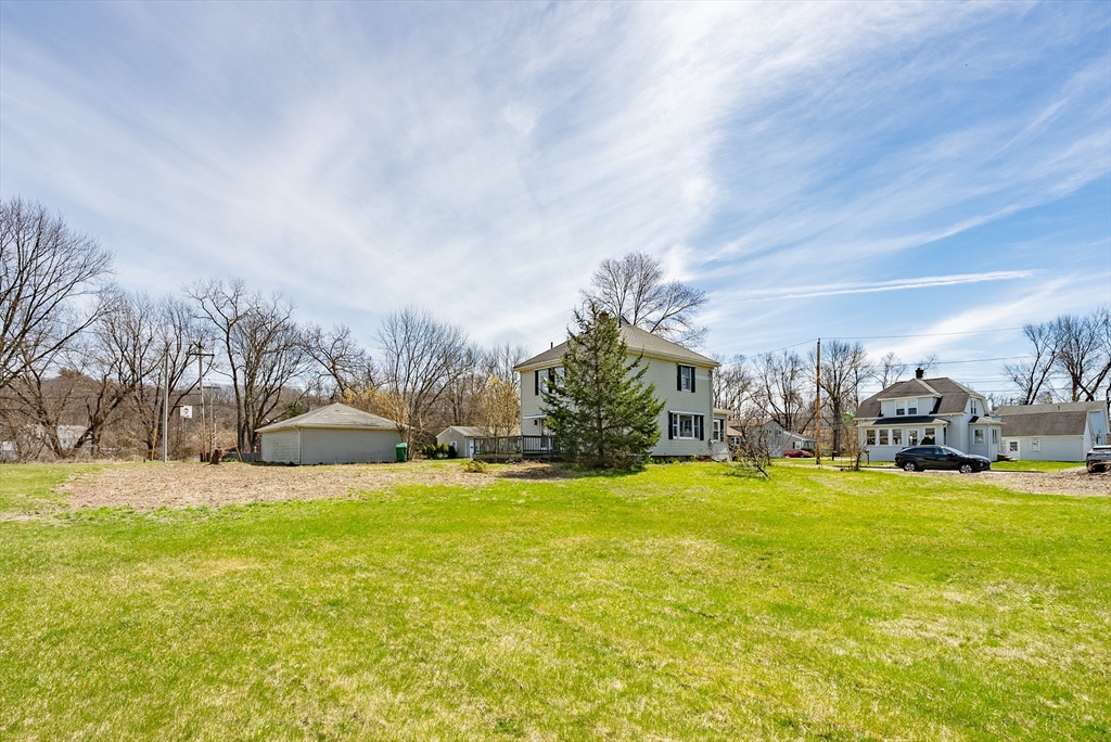 10 Bill Street Chicopee, MA 01013 - Photo 38 of 41 a view of a swimming pool with lawn chairs and large trees