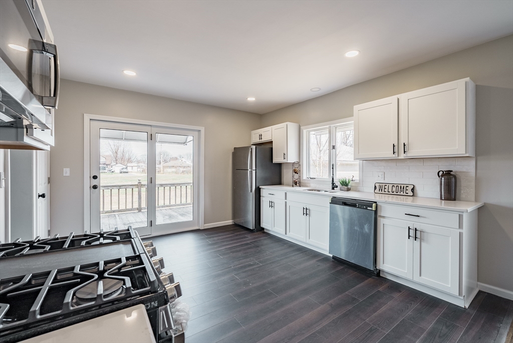10 Bill Street Chicopee, MA 01013 - Photo 7 of 41 a kitchen with a stove a sink and a refrigerator