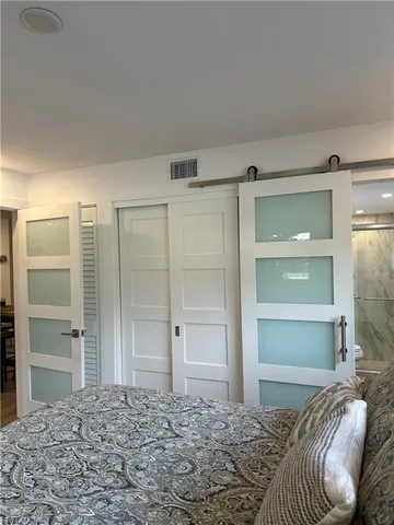 a bedroom with a bed and a closet