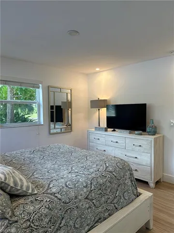 a living room with a bed and flat screen tv