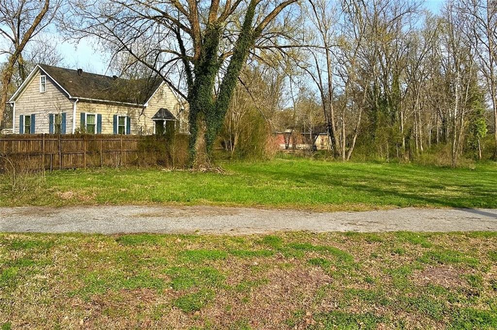 204 Myrtle Street Southwest Rome, GA 30161 - Photo 1 of 1 a view of a house with a big yard and large trees